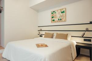 a bedroom with a white bed with a tray on it at Hotel Robson - Smart Hotel in Lloret de Mar