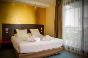 Postel nebo postele na pokoji v ubytování Appart Hôtel Clément Ader