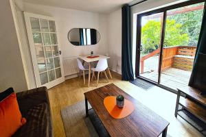 a living room with a couch and a table at 2 Bedroom GF Home - Private Parking and Garden in Lancaster