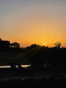 a sunset with the sun setting in the background at Dar Al Manar in El Jadida