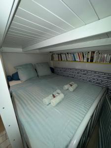 a bed with two rolled up towels on it at T2 Mer et Soleil avec Terrasse in Sète