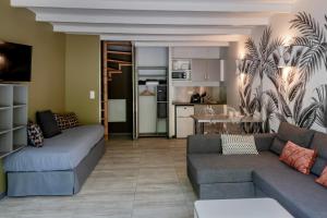 a living room with two couches and a kitchen at Smartappart Caen Grusse in Caen
