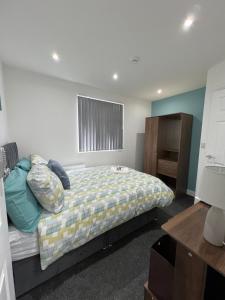 a bedroom with a bed and a window at OnPoint Home in Coventry