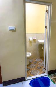 a bathroom with a toilet and a sink at Tina Homestay in Burgos +4 photos
