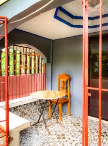 a table and chair in a room with a window at Tina Homestay in Burgos