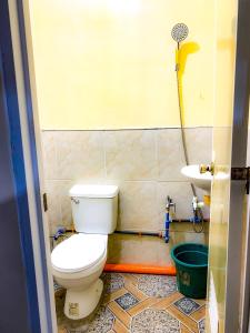 a bathroom with a toilet and a sink at Tina Homestay in Burgos