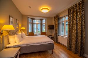 Postel nebo postele na pokoji v ubytování Hotel Rusthållargården