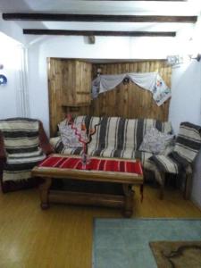 una sala de estar con un sofá y dos sillas en Casa Maira, en Ranca