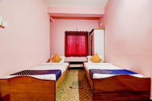Hotel O NANDINI客房内的一张或多张床位