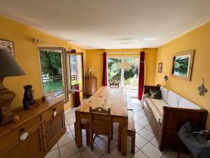 a living room with a table and a couch at Chalet La Madelon - Idéal pour les grandes familles in Hérémence +26 photos