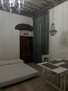 a room with a table and a bed and a dining room at Chez Sophie in La Spezia