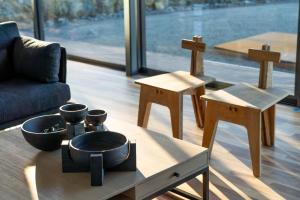 a living room with wooden tables and a couch at Mountain Top Snug, House Itas in Snug
