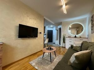 a living room with a couch and a table at Timeout Apartment in Brčko