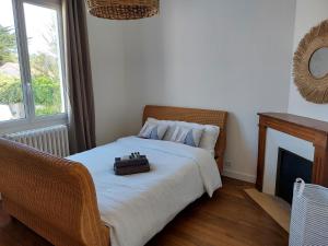 a bedroom with a bed with a suitcase on it at La Désirade in Saint-Jean-de-Monts