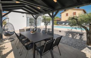 a patio with a table and chairs and a pool at Villa Mia in Frata