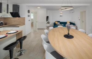 a kitchen and dining room with a wooden table and chairs at Villa Mia in Frata