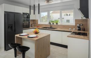 a kitchen with a island with a bowl of fruit on it at Villa Mia in Frata +30 photos