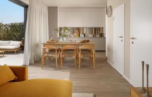 a kitchen and dining room with a table and chairs at Nice Home In Porec With Wifi in Poreč