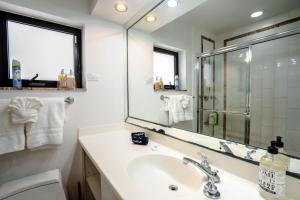 a bathroom with a sink and a mirror and a toilet at B efficiency Off Las Olas on water free kayaks in Fort Lauderdale +9 photos