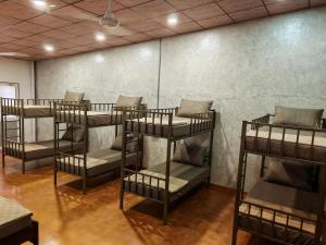 a row of bunk beds in a room at Trail Town Lodge in Haputale