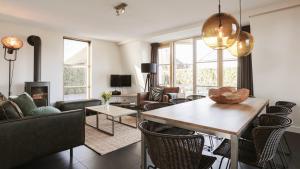 a living room with a table and chairs at OUD Duynvallei in Schoorl