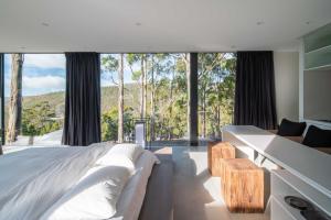 une chambre avec un lit et une grande fenêtre dans l'établissement Mountain Top Snug, Studio Itas, à Snug