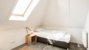 a bed in a room with a window at OUD Duynvallei in Schoorl +281 photos