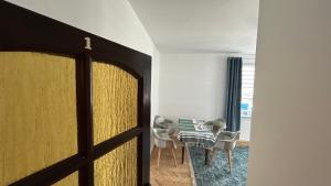 a door leading into a dining room with a table and chairs at Apartament Rodzinny Nad Morzem, Gdynia in Gdynia +10 photos
