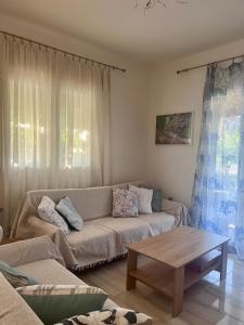 a living room with a couch and a coffee table at Beverly house in Kriopigi