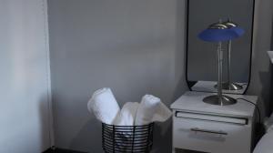 a room with a lamp and a basket with towels at HOPE-always in Cape Town