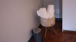 a basket filled with white towels in a room at HOPE-always in Cape Town
