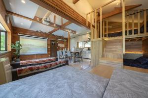 a living room with a large television and a dining room at Private hot-spring Villa in Kusatsu #projector in Kusatsu