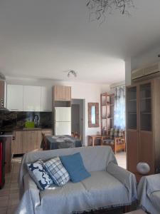 a living room with a couch and a kitchen at Beverly house in Kriopigi