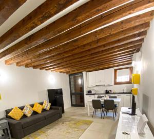 a living room with a couch and a kitchen at Isa Lovely Home in Venice in Venice