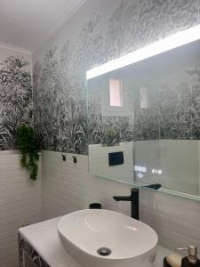 a bathroom with a white sink and a mirror at Beverly house in Kriopigi +19 photos