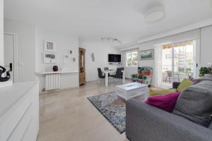 a living room with a couch and a table at Apartamentos Oasis in Albir