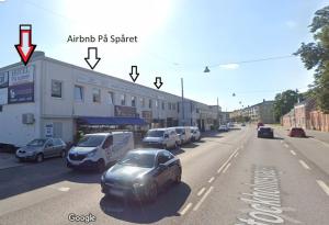 a street with cars parked on the side of the road at Nr7 På Spåret in Norrköping