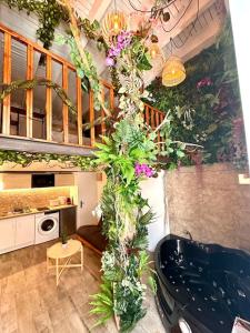 a bathroom with a tub with plants on the wall at Jungle avec Jaccuzi au coeur de Nice in Nice +41 photos