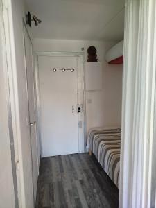 a room with a door leading to a room with a bed at Île du Frioul in Marseille +3 photos
