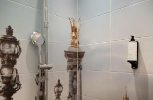 a shower in a bathroom with a mirror at Hôtel Petit Saint-Honoré in Paris