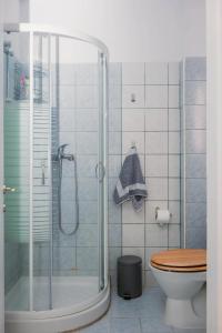 a bathroom with a shower and a toilet at Nowhere Stay in Pefkohori +64 photos