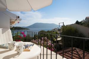 a balcony with a view of the ocean at Vassili's Apartment, Kefalonia in Fiskardo