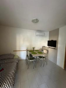 a room with a table and chairs and a tv at Apartmani Mersol Nin in Nin +51 photos