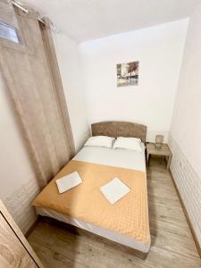 a small bedroom with a bed in a room at Montenegrina Apartment in Budva