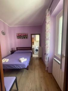a bedroom with purple walls and a bed in a room at Porta Romana apartment in Ronciglione