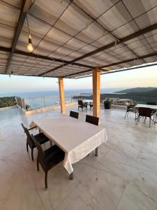 a large patio with a table and chairs and the ocean at Montenegrina Apartment in Budva