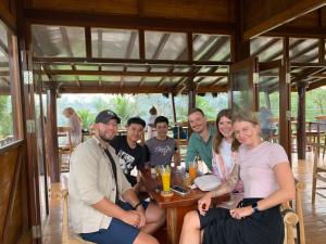 a group of people sitting at a table in a restaurant at Bale Tetebatu in Tetebatu