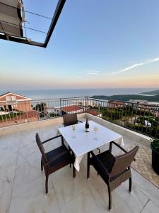 a white table and chairs on a balcony with a view at Montenegrina Apartment in Budva