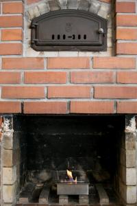 a brick fireplace with a tv on top of it at BohoSauna in Oulu