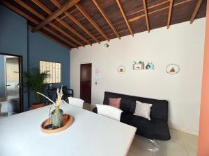 a living room with a white table and a couch at Apartamento Relax in Medellín +37 photos